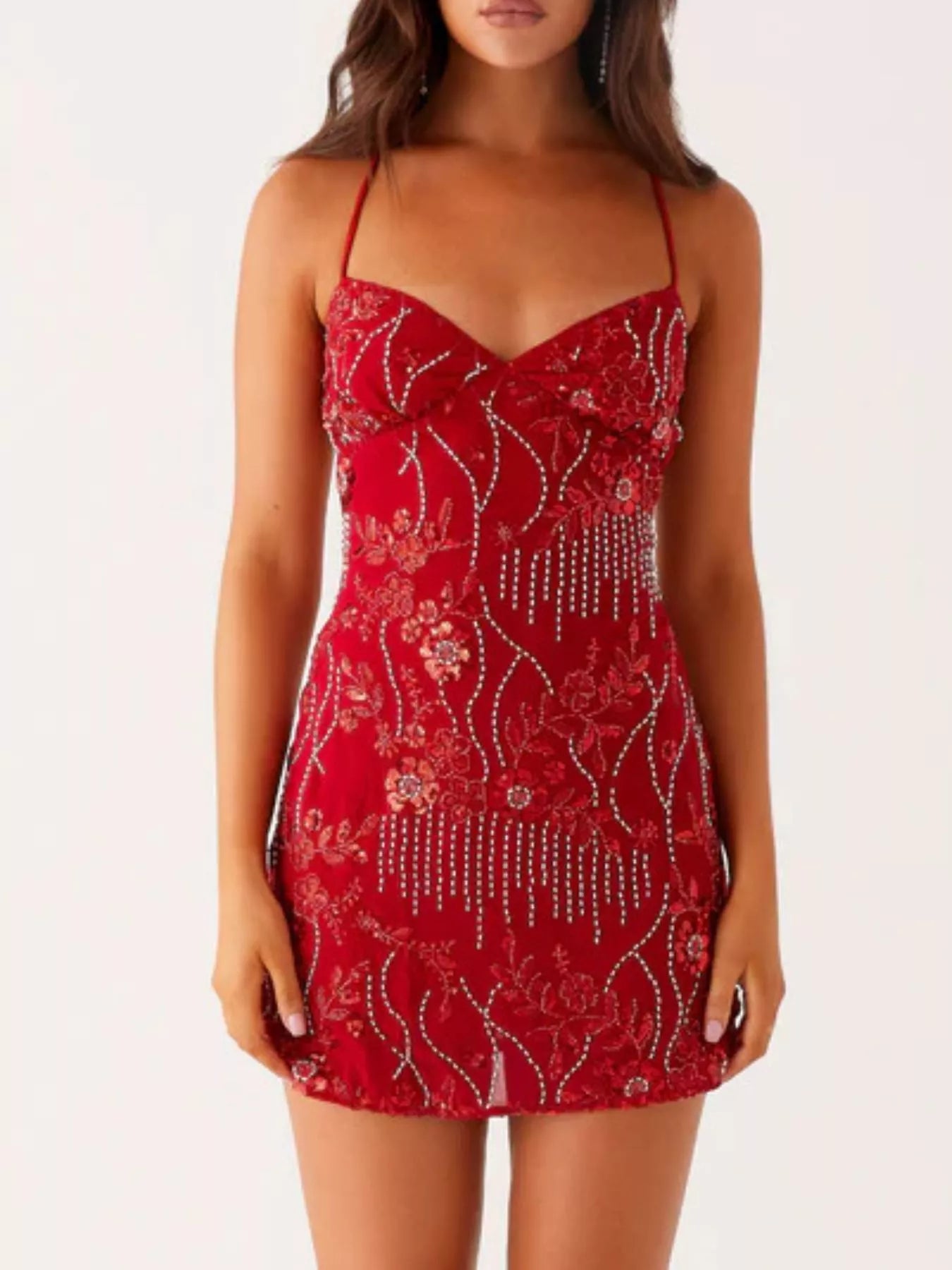 Red dress with floral patterns and embellishments on a white background
