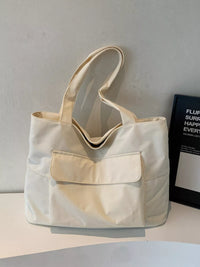 Beige tote bag on a light gray surface with a neutral background
