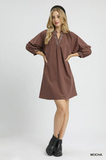 Woman wearing a brown dress with a white background