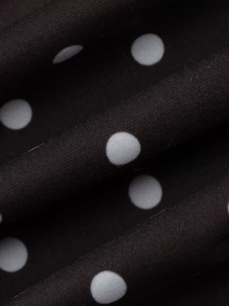 Close-up of black fabric with white polka dots