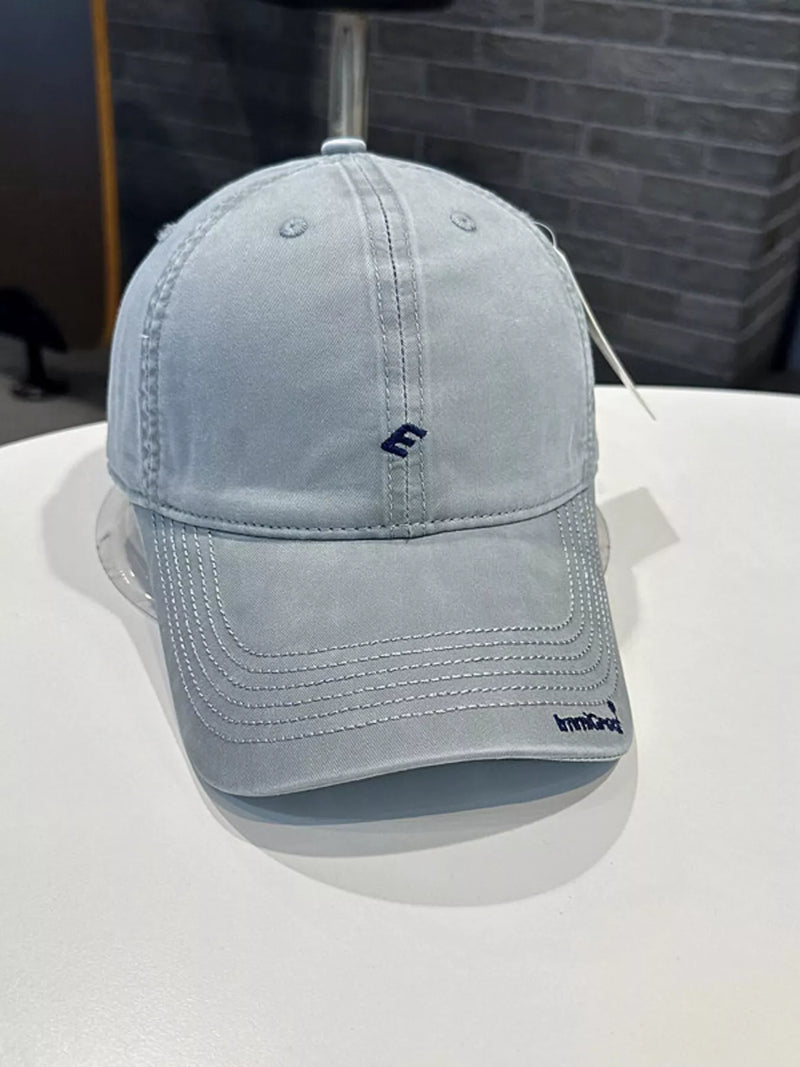 Light blue baseball cap with a brand logo on a white surface