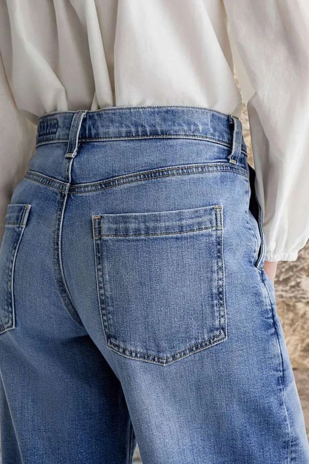 Close-up of blue jeans with a neutral background