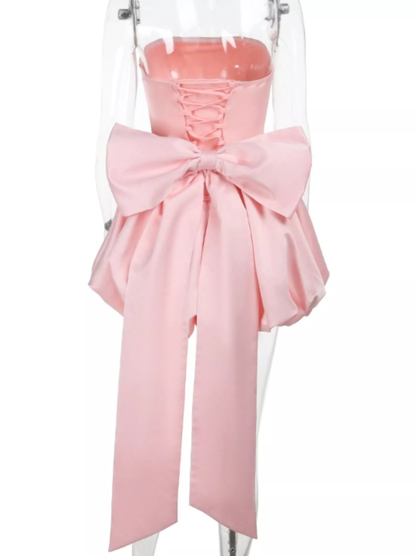 Pink dress with a large bow on a mannequin against a white background