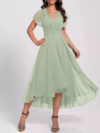 Woman wearing a light green dress on a white background
