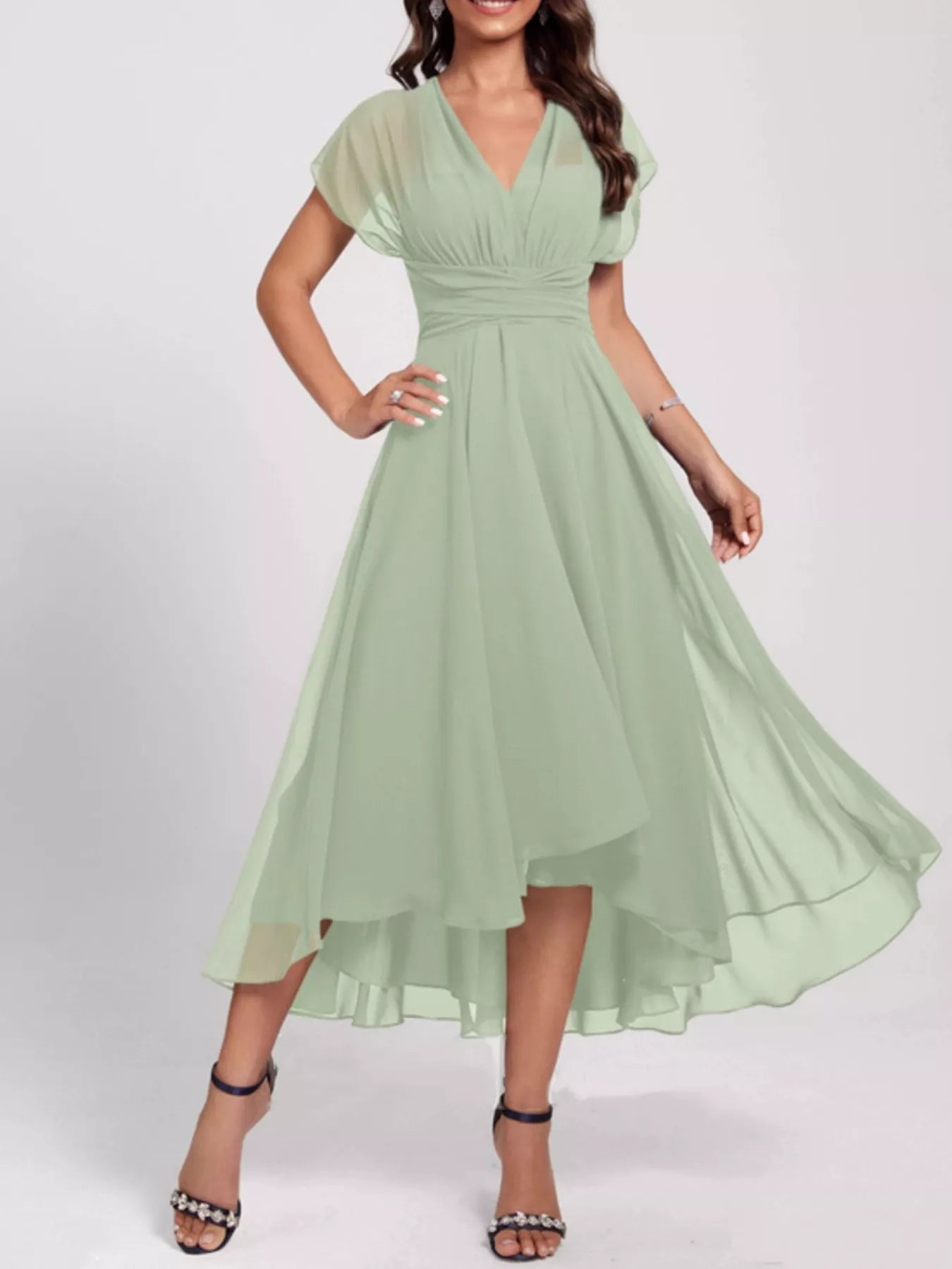 Woman wearing a light green dress on a white background