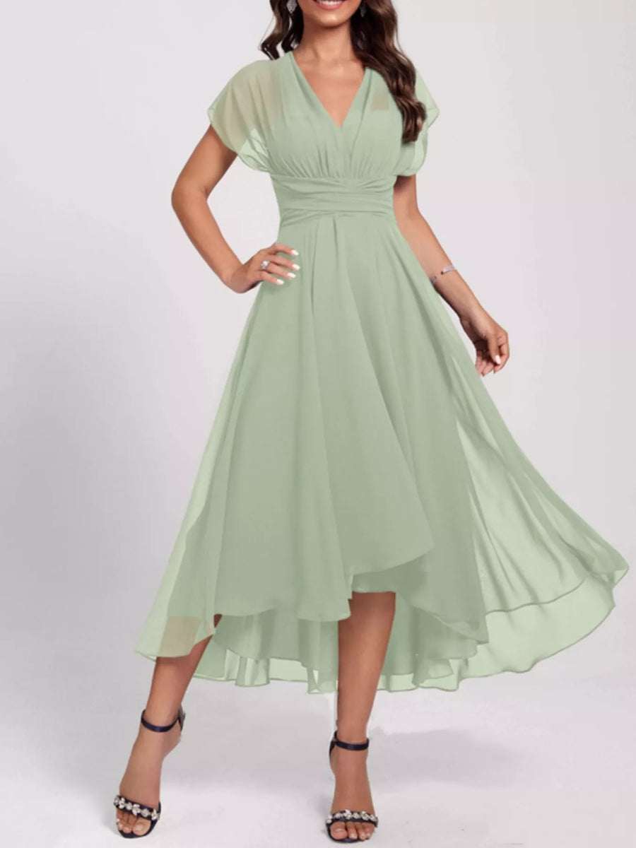 Woman wearing a light green dress on a white background