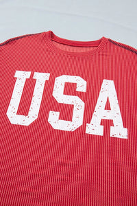 Red shirt with 'USA' printed in white on a light gray background