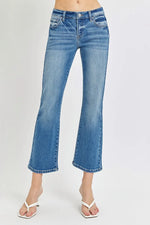 Blue jeans worn by a person on a white background
