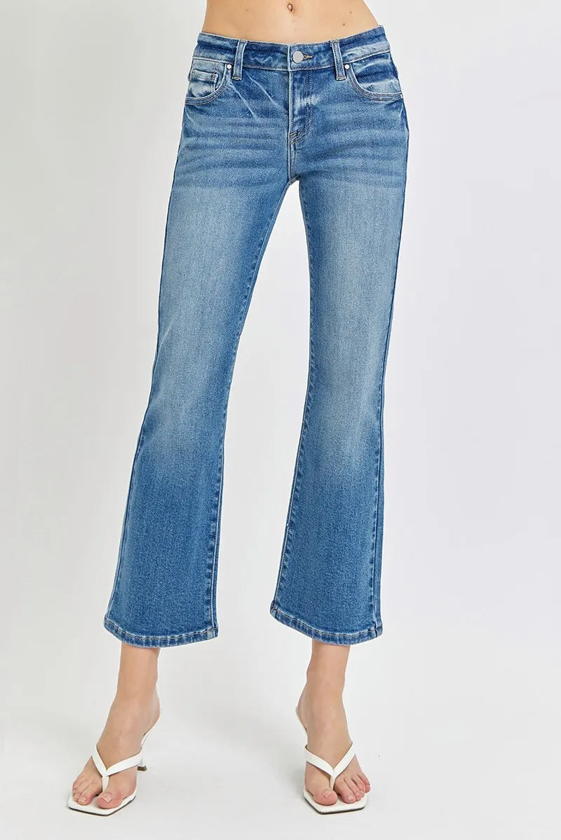 Blue jeans worn by a person on a white background