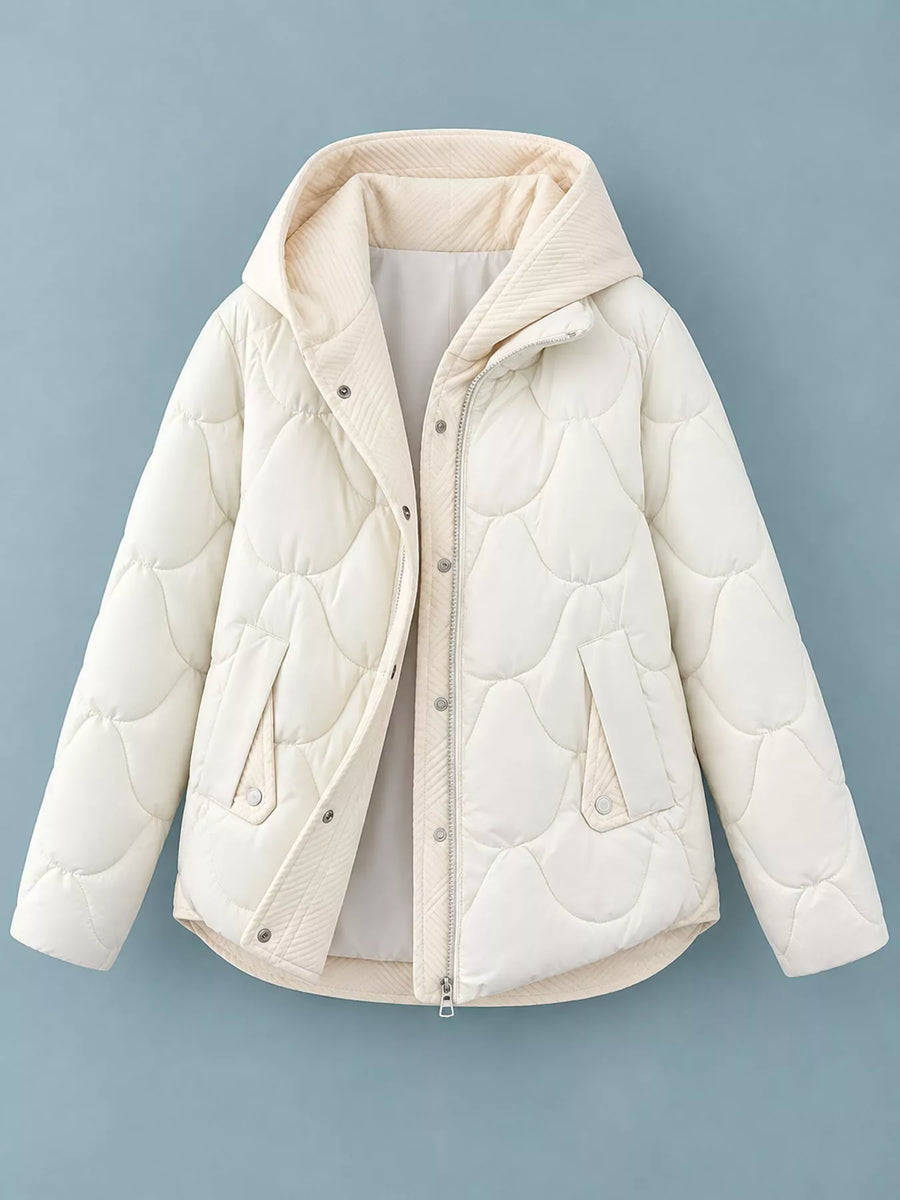 A cream-colored quilted puffer jacket with a hood, shown flat against a solid blue-gray background.