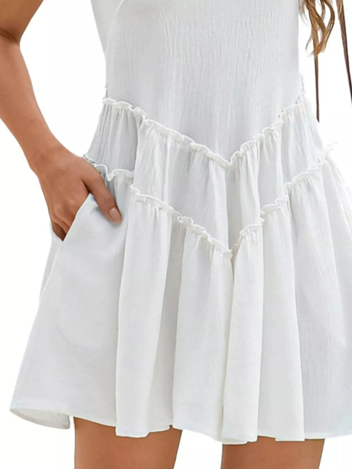 White dress with ruffled hem on a plain background