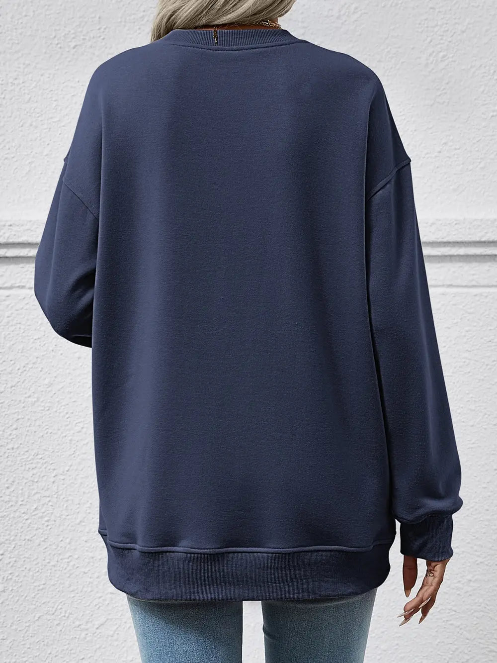 Navy blue sweatshirt worn by a person on a light gray background