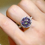Ring with a large purple gemstone on a finger