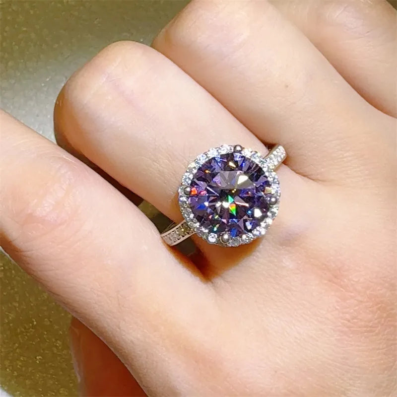 Ring with a large purple gemstone on a finger