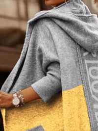 Person wearing a gray and yellow jacket with a blurred background