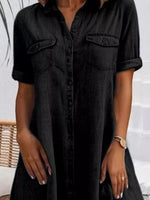 Black denim dress worn by a person with a neutral background
