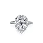 Diamond ring with pear-shaped center stone on a white background