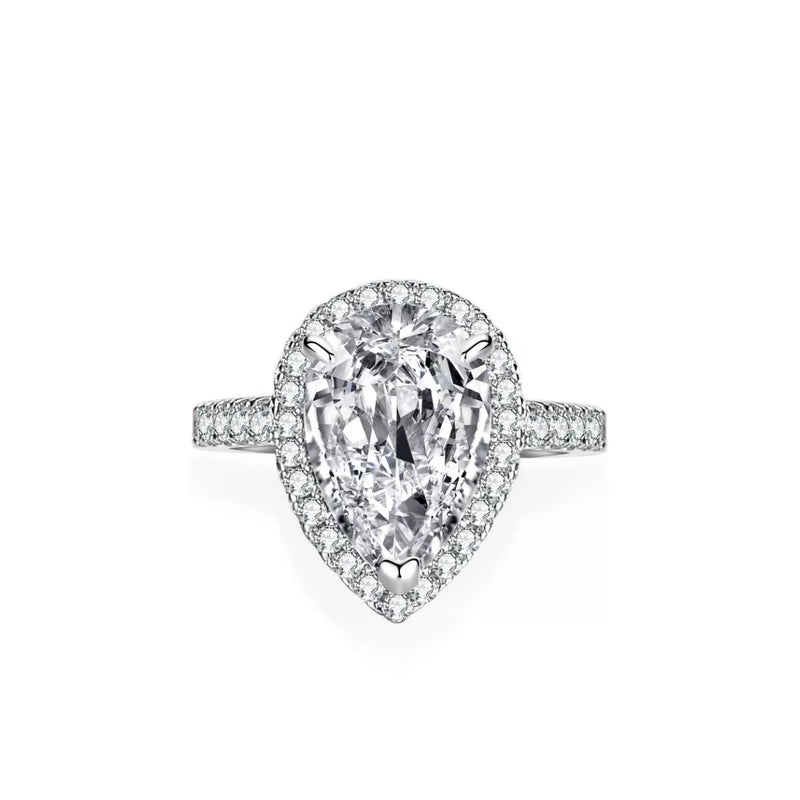 Diamond ring with pear-shaped center stone on a white background