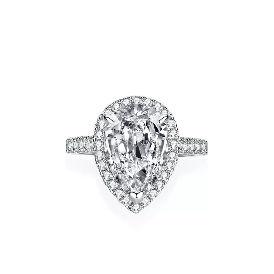Diamond ring with pear-shaped center stone on a white background