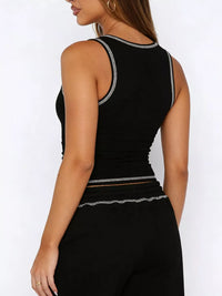 Black tank top with silver trim worn by a person on a white background