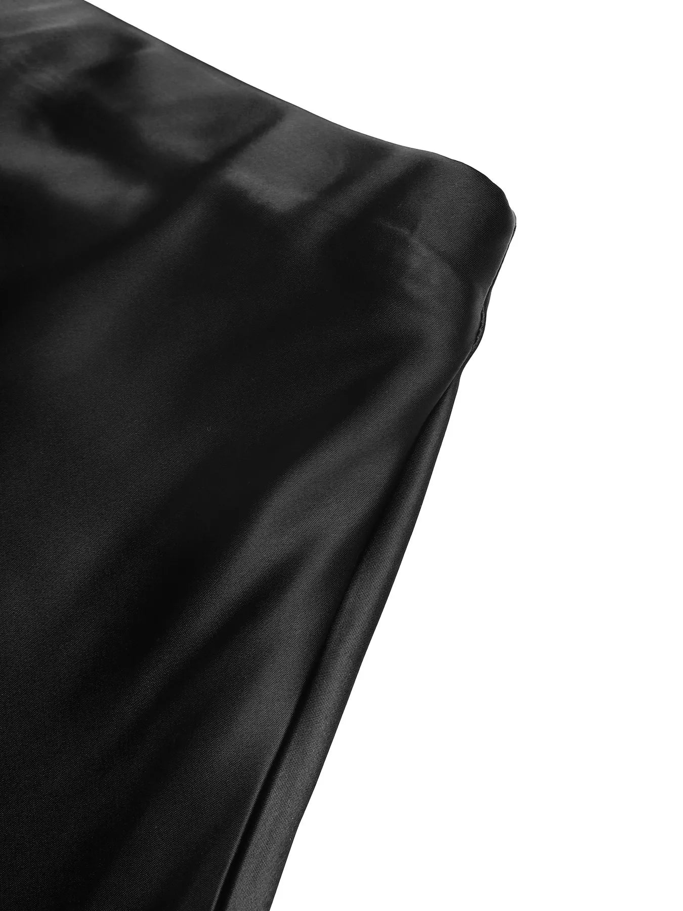 Close-up of black satin fabric on a white background