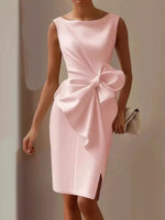 Pink dress with a large bow detail on a neutral background