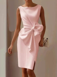 Pink dress with a large bow detail on a neutral background