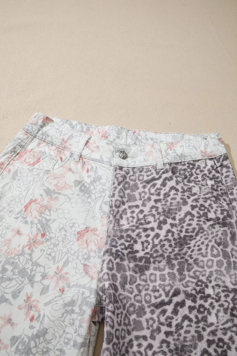 Two pairs of pants with floral and leopard print on a beige background
