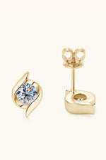 Gold earrings with a central gemstone on a white background