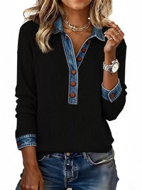 Black sweater with denim collar and cuffs worn by a person on a white background
