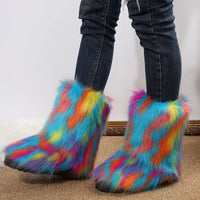 Colorful fuzzy boots worn with jeans on a neutral background