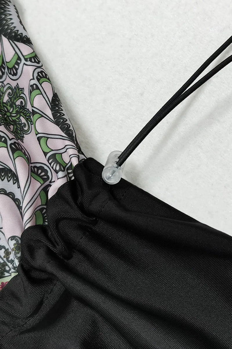 Close-up of a drawstring on a black bag with a patterned fabric background