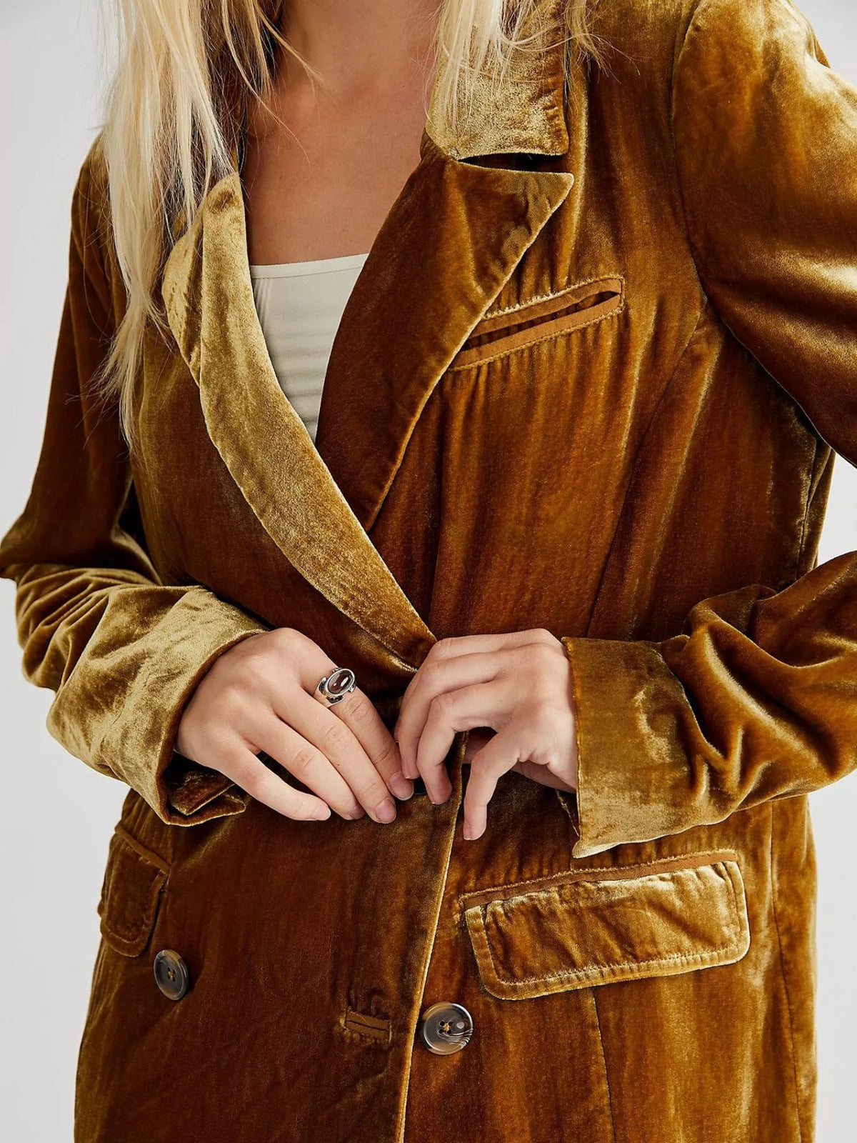 Brown velvet jacket worn by a person on a white background