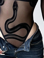 Close-up of a person wearing sheer black fishnet lingerie with a large black snake graphic across the torso, paired with low-rise blue jeans.
