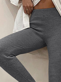 Gray ribbed leggings worn by a person on a neutral background