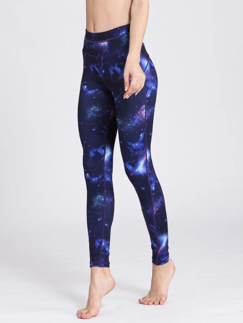 Person wearing galaxy-themed leggings on a white background