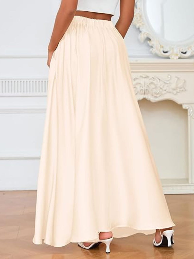 Person wearing a long beige skirt in an elegant room setting.