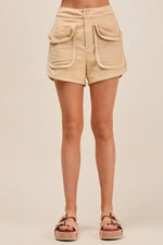 Beige shorts with pockets on a beige background