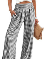 Black and white checkered pants worn by a person on a white background