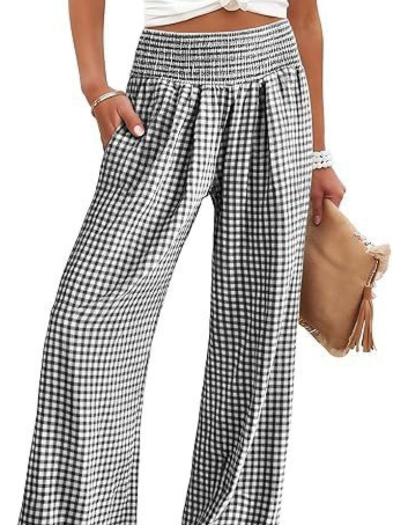 Black and white checkered pants worn by a person on a white background