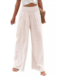 Beige wide-leg pants worn by a person on a white background