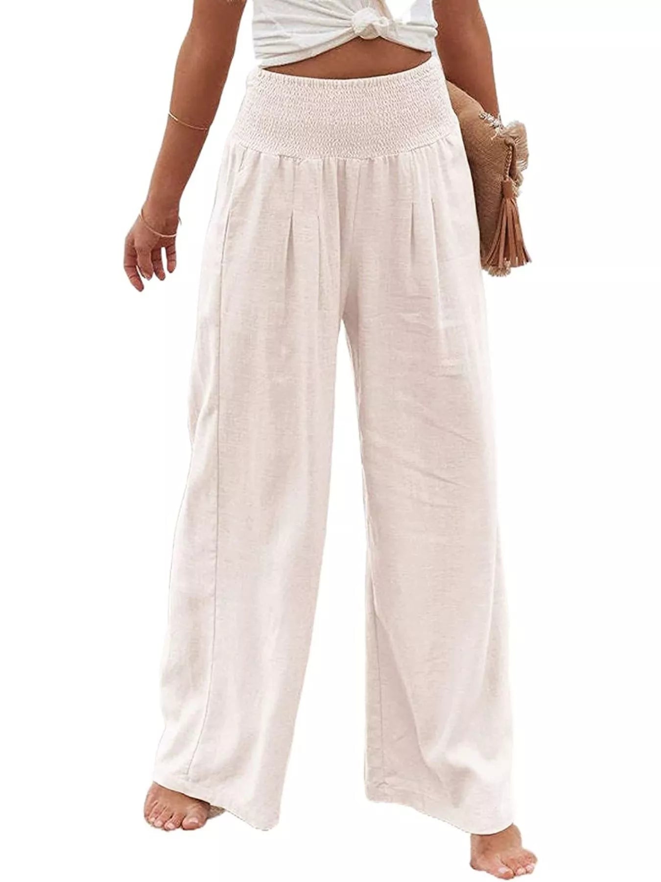Beige wide-leg pants worn by a person on a white background