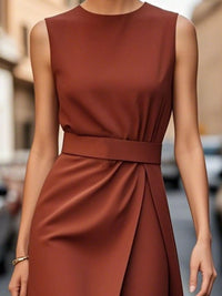 Brown sleeveless dress worn by a person on a blurred street background