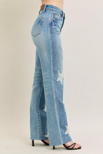 Light blue jeans with a star design on a beige background