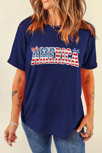 Person wearing a blue t-shirt with 'AMERICA' printed in red and white letters on a beige background