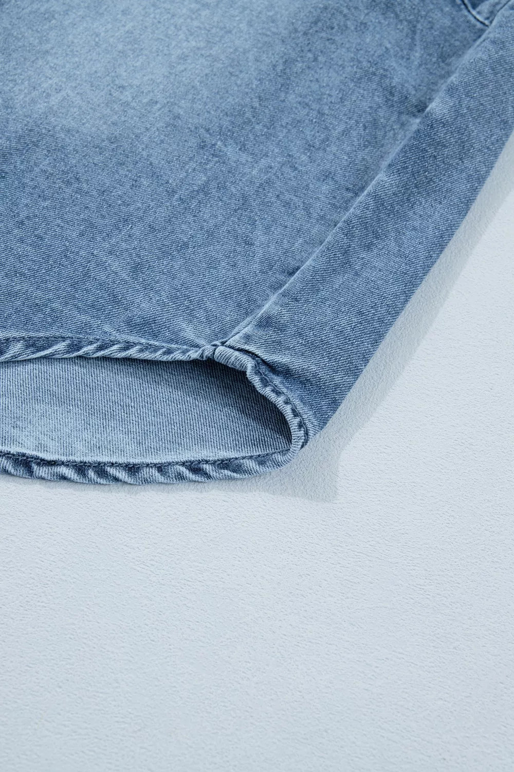 Close-up of a blue denim fabric on a light gray background
