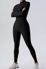 Person wearing a black jumpsuit on a light gray background