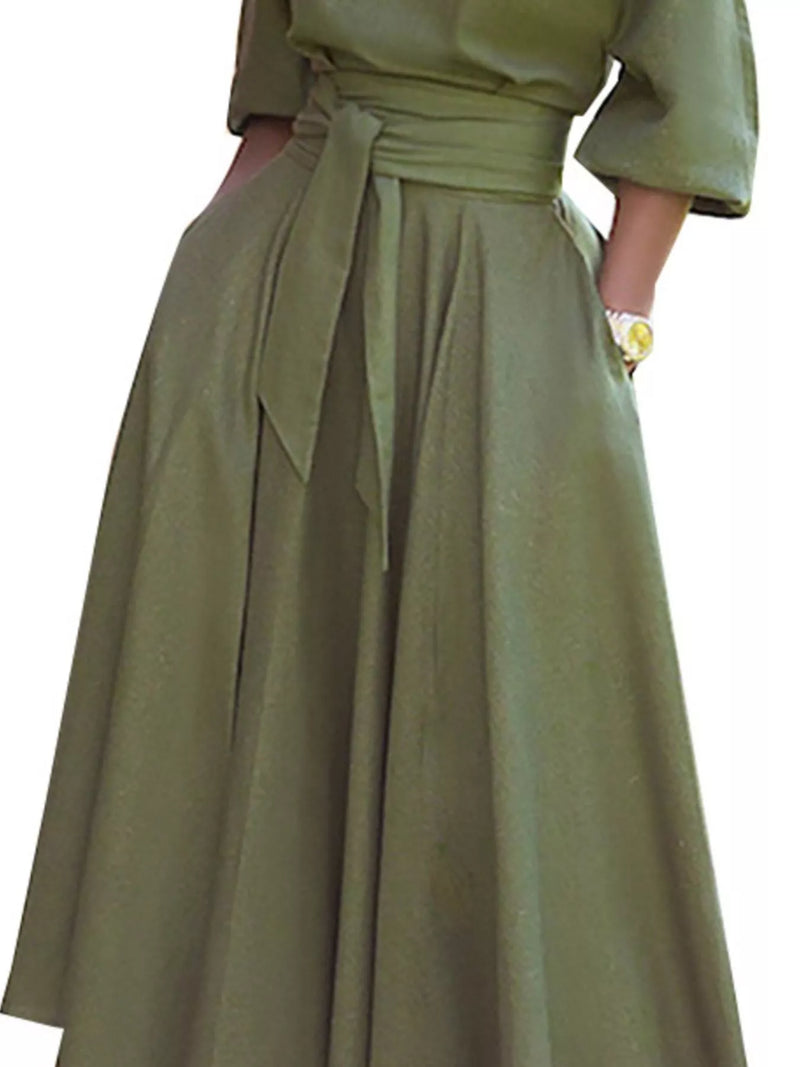 Green dress with a belt on a white background