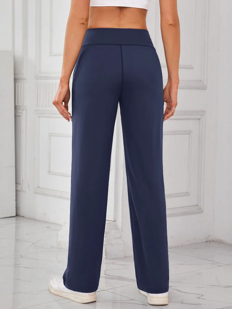 Navy blue pants worn by a person in a minimalistic setting