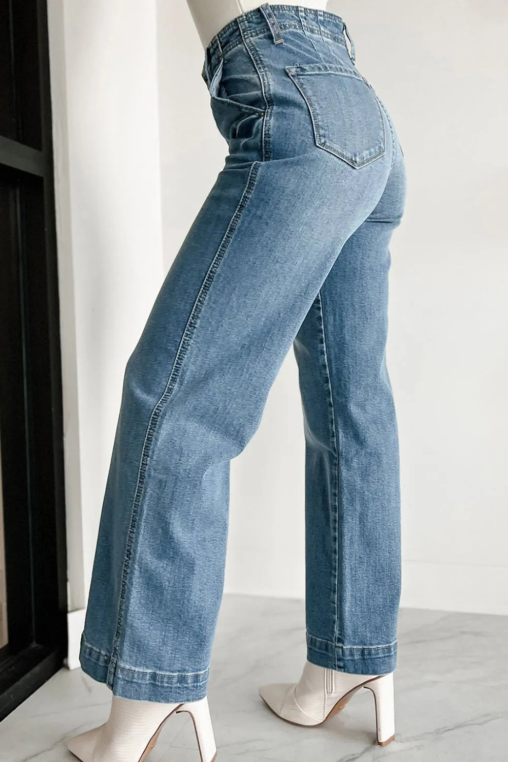 Blue jeans on a mannequin against a white background